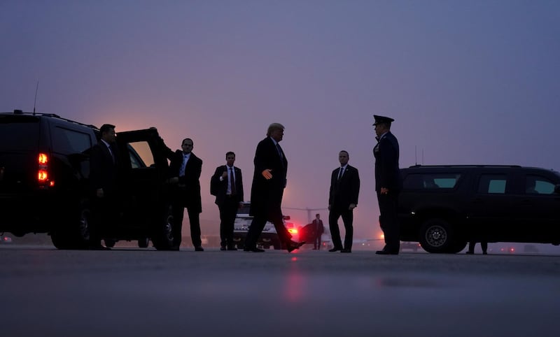 US President Donald Trump boards Air Force One on a foggy evening as he departs Joint Base Andrews in Maryland.  Reuters