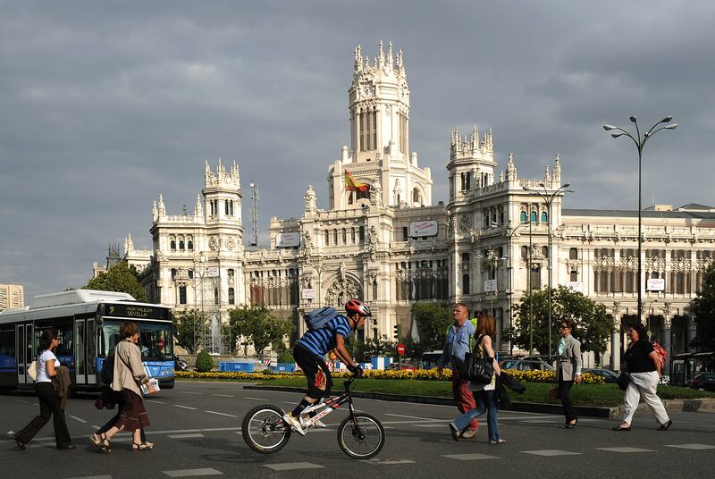 FILE: Pedestrians cross the road near the town hall at Plaza Cibeles in Madrid, Spain on Wednesday, Sept. 24, 2009. Madrid's 2016 Olympic Games bid officials said the city's plans are more financially viable than those of rivals Tokyo, Chicago and Rio de Janeiro amid the global economic crisis. Photographer: Denis Doyle/Bloomberg
