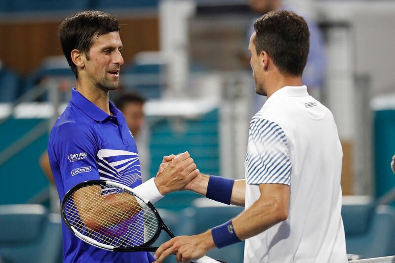 Mar 26, 2019; Miami Gardens, FL, USA; Roberto Bautista Agut of Spain (R) shakes hands with Novak Djokovic of Serbia (L) in the fourth round of the Miami Open at Miami Open Tennis Complex. Mandatory Credit: Geoff Burke-USA TODAY Sports