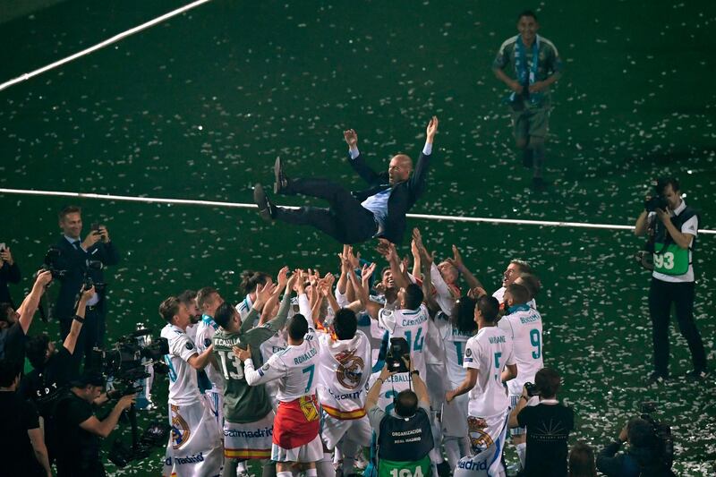 Real Madrid's players toss coach Zinedine Zidane while Real Madrid celebrate their Champions League Final win at Santiago Bernabeu, Madrid, Spain. May 27, 2018. Gabriel Bouys / AFP