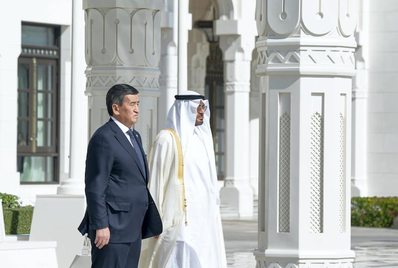 ABU DHABI, UNITED ARAB EMIRATES -December 12, 2019: HH Sheikh Mohamed bin Zayed Al Nahyan, Crown Prince of Abu Dhabi and Deputy Supreme Commander of the UAE Armed Forces (R) and HE Sooronbay Sharipovich Jeenbekov, President of Kyrgyzstan (L) stand for the national anthem during an official visit reception, at Qasr Al Watan. 

( Hamad Al Mansoori for the Ministry of Presidential Affairs )

---