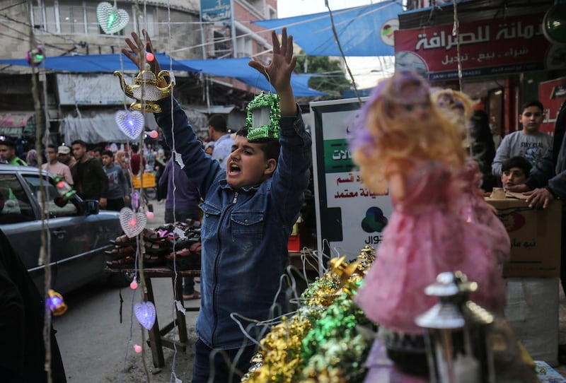 A Palestinian boy seller showcases Chinese-made "fanous" lanterns in Khan Yunis in the southern Gaza Strip.  AFP