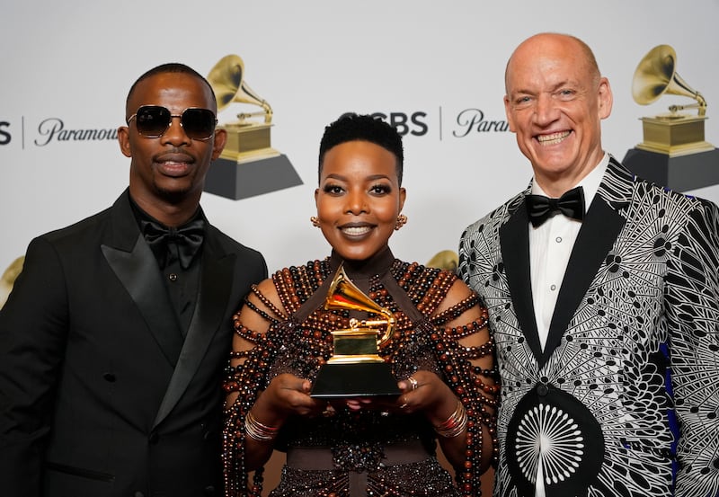 Zakes Bantwini, from left, Nomcebo Zikode and Wouter Kellerman with the award for Best Global Music Performance for Bayethe. AP