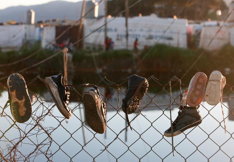 Shoes hang on a fence at a makeshift settlement in Bar Elias, in the Bekaa Valley, Lebanon. Reuters