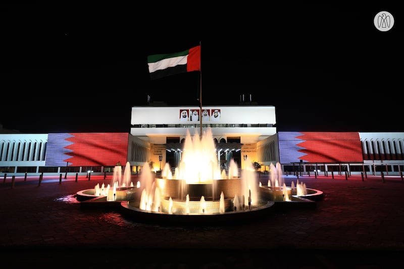Al Ain Municipality building features the red and white of the Bahrain flag to mark Bahrain National Day.