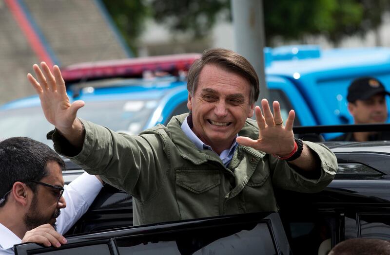 In this Oct. 28, 2018 photo, Jair Bolsonaro, presidential candidate with the Social Liberal Party, waves after voting in the presidential runoff election in Rio de Janeiro, Brazil. Bolsonaro is running against leftist candidate Fernando Haddad of the Workers' Party. (AP Photo/Silvia izquierdo)