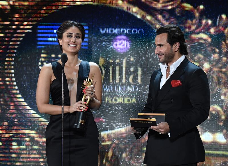 Bollywood actress Kareena Kapoor and Bollywood actor Saif Ali Khan present the award for Best Playback Male Singer at the 2014 International Indian Film Academy (IIFA) Awards. AFP