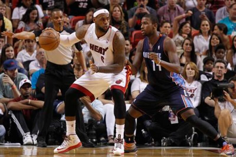 Charlotte Bobcats' Michael Kidd-Gilchrist guards LeBron James at the American Airlines Arena.