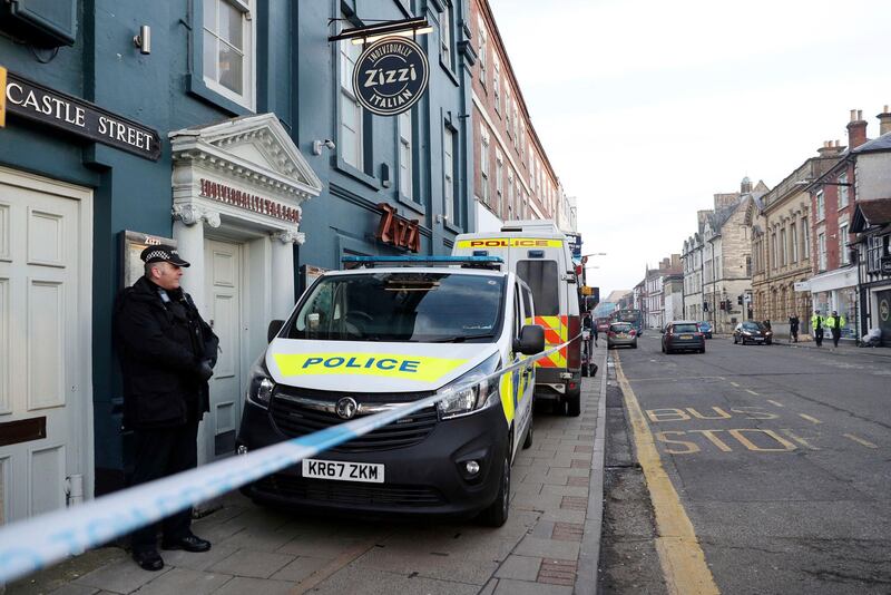 A policeman stands outside the Zizzi restaurant in Salisbury, England Wednesday, March 7, 2018 near to where former Russian double agent Sergei Skripal was found critically ill. Britain's counterterrorism police took over an investigation Tuesday into the mysterious collapse of a former spy and his daughter, now fighting for their lives. The government pledged a "robust" response if suspicions of Russian state involvement are proven. Sergei Skripal and his daughter are in a critical condition after collapsing in the English city of Salisbury on Sunday. (Andrew Matthews/PA via AP)