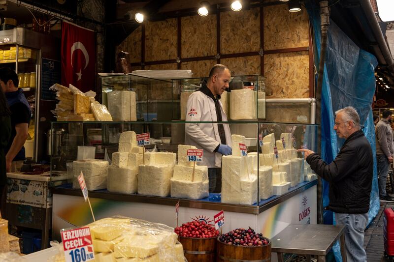 A  customer at a cheese and fresh produce store in Istanbul