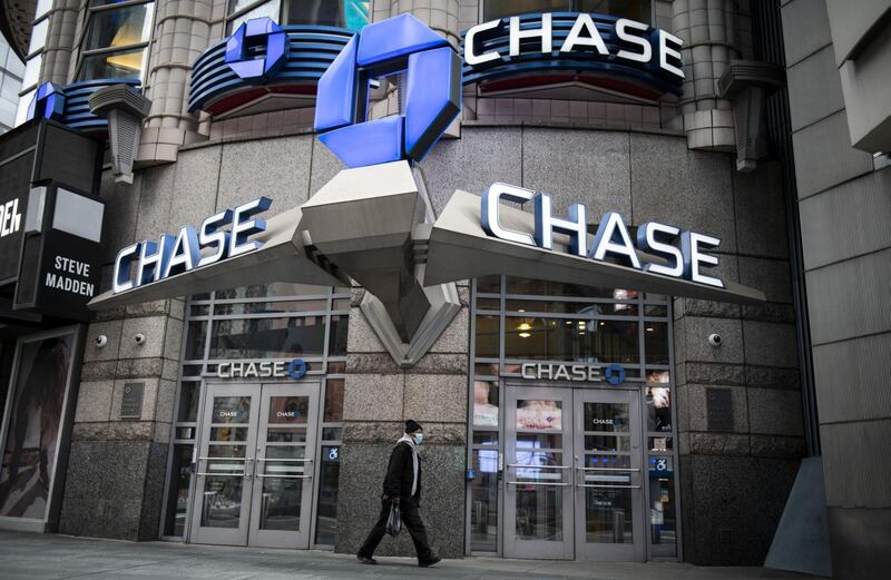 A pedestrian wearing a protective mask walks past a JPMorgan Chase & Co. bank branch in New York, U.S., on Friday, April 10, 2020. JPMorgan Chase is scheduled to release earnings figures on April 14. Photographer: Mark Kauzlarich/Bloomberg