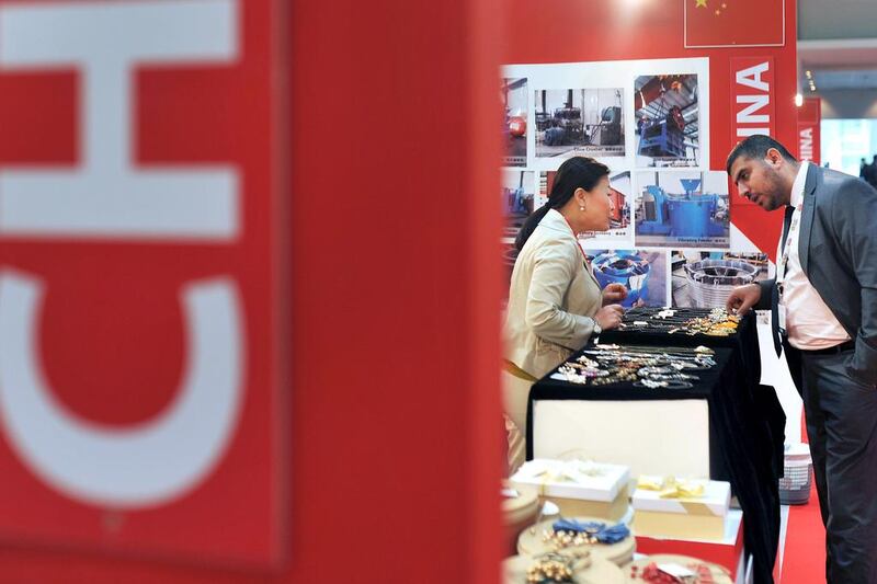 A visitor browses for jewellery at a booth during the China Trade Week exhibition at ADNEC in Abu Dhabi. Delores Johnson / The National 