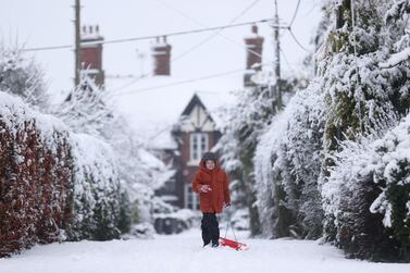 A child walks through the snow in Keele, Staffordshire, Britain, December 28, 2020. REUTERS/Carl Recine