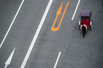 A rickshaw puller carries a tourist near Sensoji Buddhist temple in the Asakusa district, Tokyo. AP