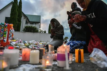 Worshippers pray at a makeshift memorial at the Al Noor mosque in Christchurch, after a terrorist attack in which 50 people were killed. EPA