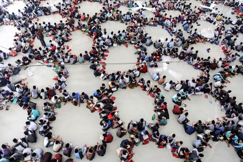 Indonesian students sit in circles as they read the Quran on the first day of Ramadan at Ar-Raudhatul Hasanah Islamic boarding school in Medan, North Sumatra, Indonesia.   EPA