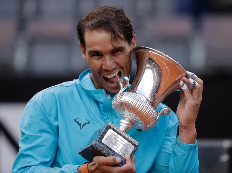 FILE - In this May 19, 2019 file photo, Rafael Nadal of Spain holds his trophy after winning against Novak Djokovic of Serbia at the end of their final match at the Italian Open tennis tournament, in Rome. Rafael Nadal is preparing his return to tennis after a seven-month layoff at next weekâ€™s Italian Open. â€œThe Foro Italico is always a special place for me and even more so this year as it will be my first tournament following a long period without playing,â€ Nadal, who has won the Rome tournament a record nine times, said in a video message played at the eventâ€™s presentation Tuesday, Sept. 8, 2020. (AP Photo/Gregorio Borgia)