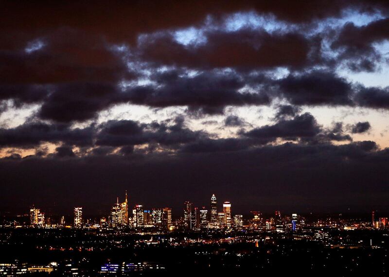 Dark clouds hang over the banking district in Frankfurt, Germany. Michael Probst / AP Photo