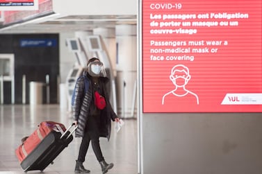 A woman wears a face mask as she walks through Montreal–Trudeau International Airport, as the Covid-19 pandemic continues in Canada and around the world. AP
