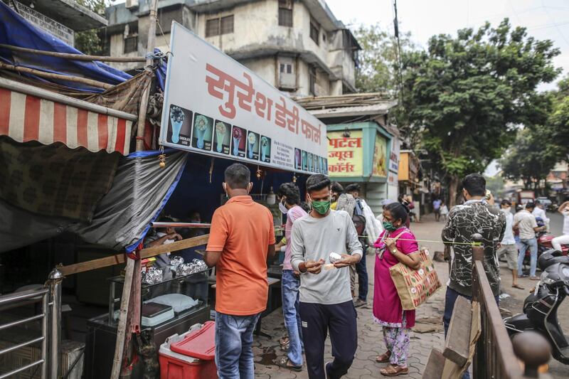 Customers wearing protective masks wait in line at a dairy store during a lockdown imposed due to the coronavirus in Mumbai, India, on Monday, June 1, 2020. Despite a strict two-month-long lockdown, the outbreak in India’s financial capital has snowballed, with the city now accounting for nearly a quarter of India’s more than 4,700 deaths and more a fifth of India’s over 165,000 infections. Photographer: Dhiraj Singh/Bloomberg