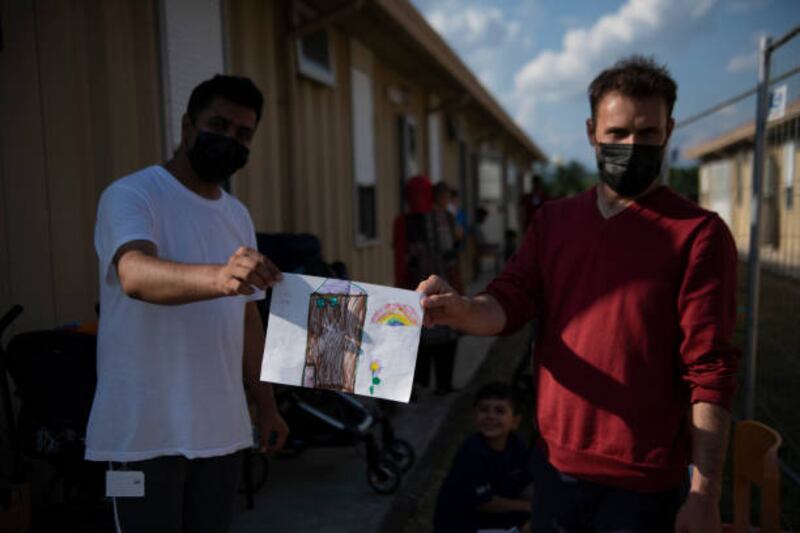 Afghan evacuees show a child's drawing at the Luigi Fenoglio Refugee Center in Settimo Torinese, managed by the Italian Red Cross. Getty Images