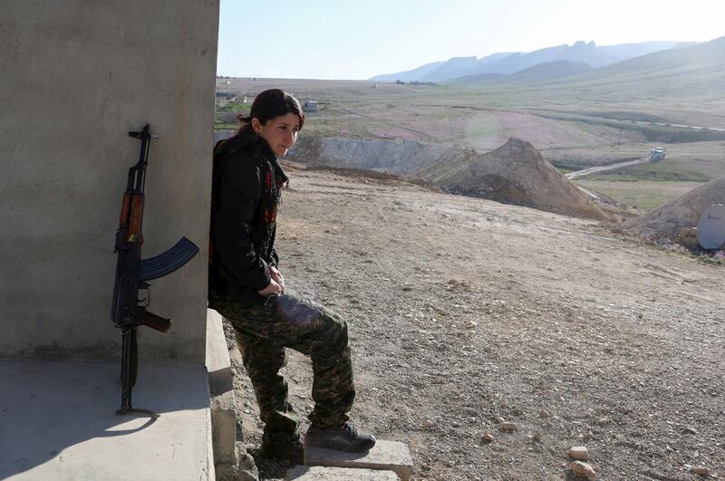 A PKK fighter outside a base in Sinjar. Many of the women have cut links with their families. They come from all corners of the Kurdish region. Asmaa Waguih / Reuters