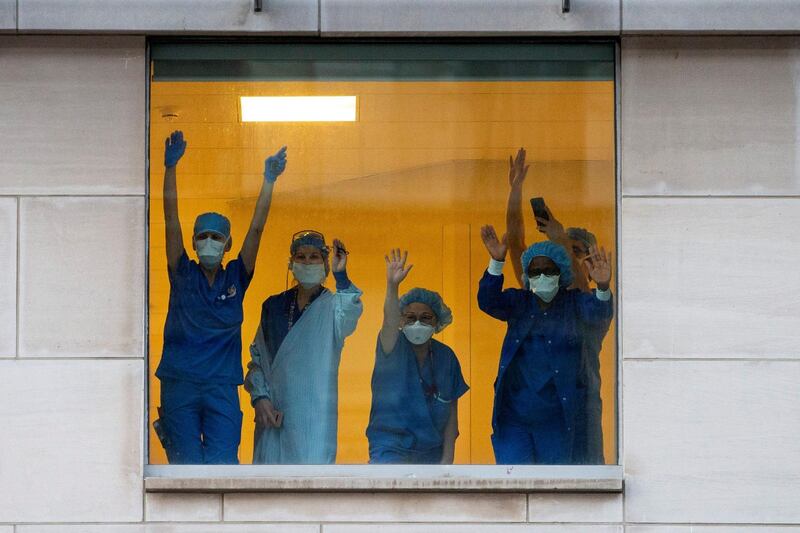 Healthcare workers clap and wave as Toronto Police and the city's front-line responders pay tribute along University Avenue as the number of coronavirus disease cases continue to grow in Toronto, Ontario, Canada. Reuters