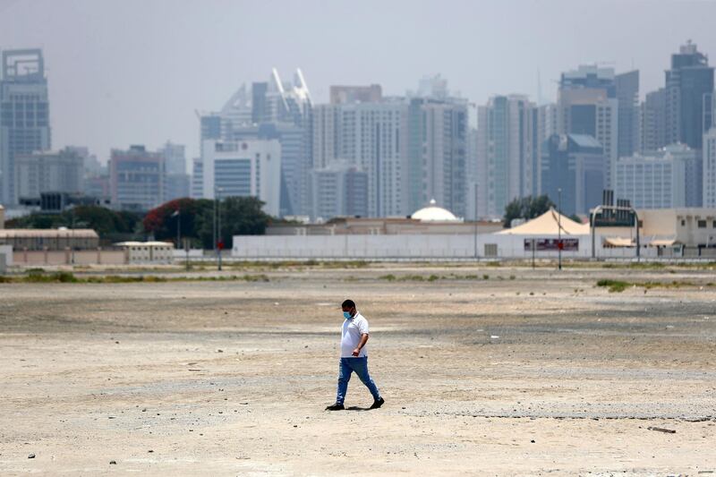 Dubai, United Arab Emirates - Reporter: N/A. Coronavirus/Covid-19. A man wears a face mask as she walks across an open space of land in Al Barsha. Sunday, June 7th, 2020. Dubai. Chris Whiteoak / The National