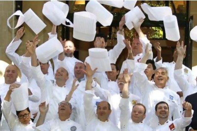 Members of the "club des chefs des chefs" throw their hats into the air before meeting in Paris. The club is made up of chefs to heads of states.