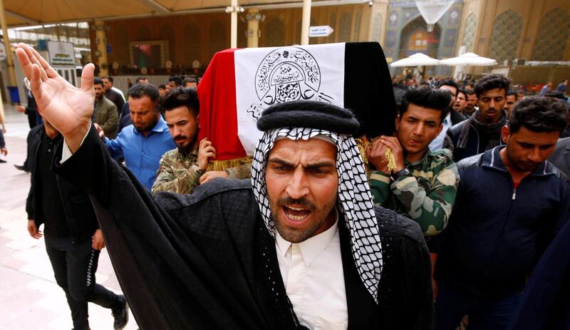 Mourners carry coffins of Iraqi Federal police officers who were killed by U.S. airstrike, during a funeral in Najaf, Iraq. REUTERS