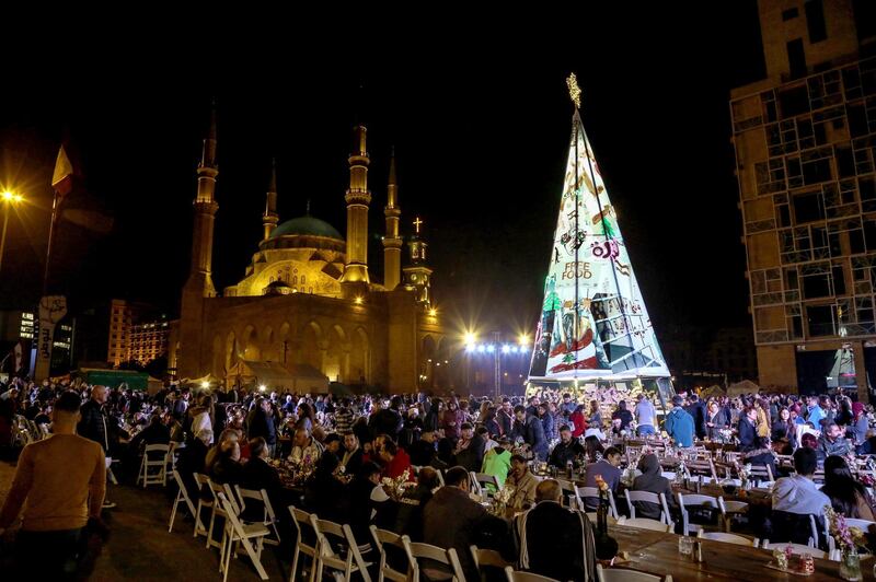 Anti-government protestors and the less fortunate attend a Christmas dinner to celebrate in Martyrs square in downtown Beirut. EPA