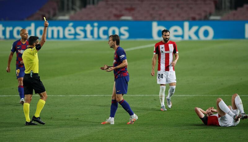 Ivan Rakitic is shown a yellow card by referee Jesus Gil Manzano. Reuters