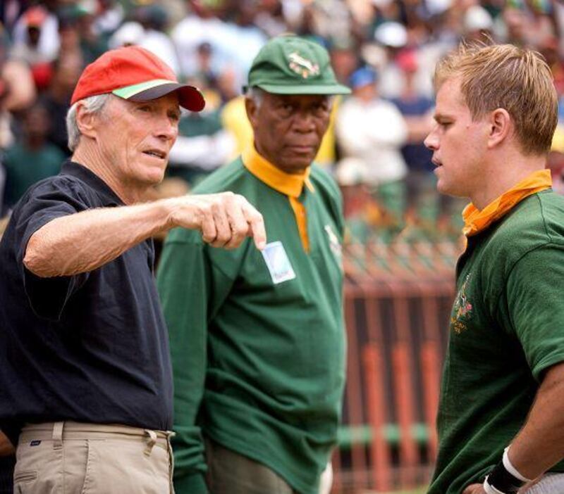 Director Clint Eastwood, left, talks with Matt Damon, right, playing the South African rugby captain, and Morgan Freeman on the set of <i>Invictus</i>