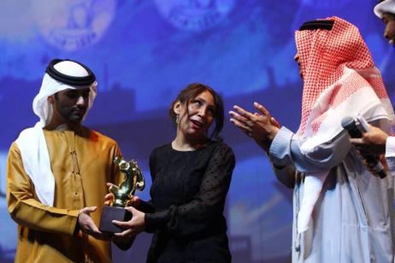Dubai, United Arab Emirates-December 16, 2012;  Haifa Al Mansour (C) the Director of te Movie " Wadjda" receives the Muhr Arab Feature Best Film at the Dubai International Film Festival in Dubai . (  Satish Kumar / The National ) For Arts & Life