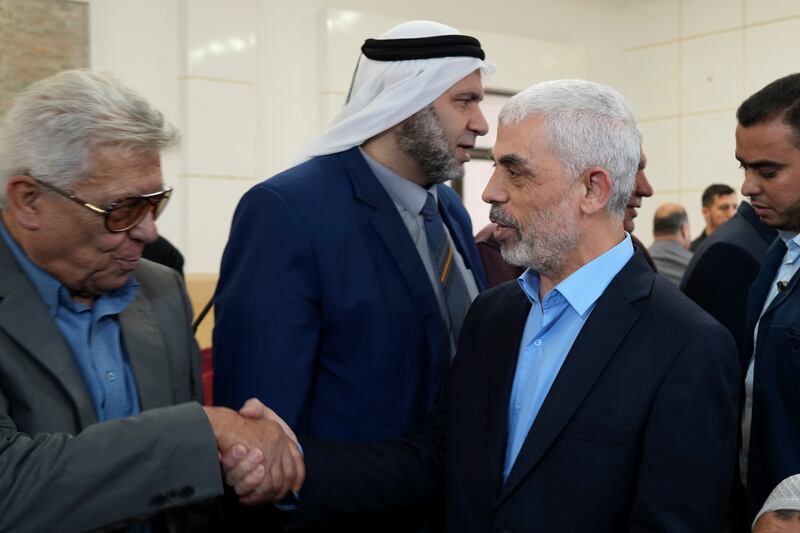 Yahya Sinwar shakes greets supporters at the meeting hall near the Gaza seaside. AP