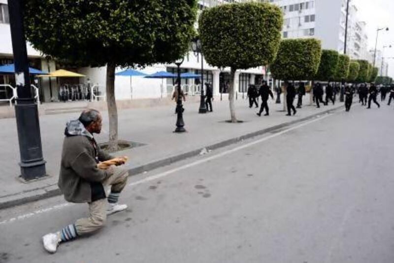 The 2011 Tunisian protests were in part symbolised by the appearance of Captain Khobza a middle-aged man who turned to confront the approaching ranks of riot police holding a baguette as if it were a machine-gun. Fred Dufour / AFP Photo