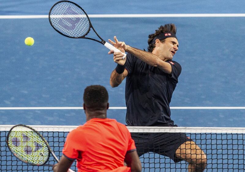 Roger Federer of Switzerland is hit on the ear by a ball from Frances Tiafoe of the USA. EPA