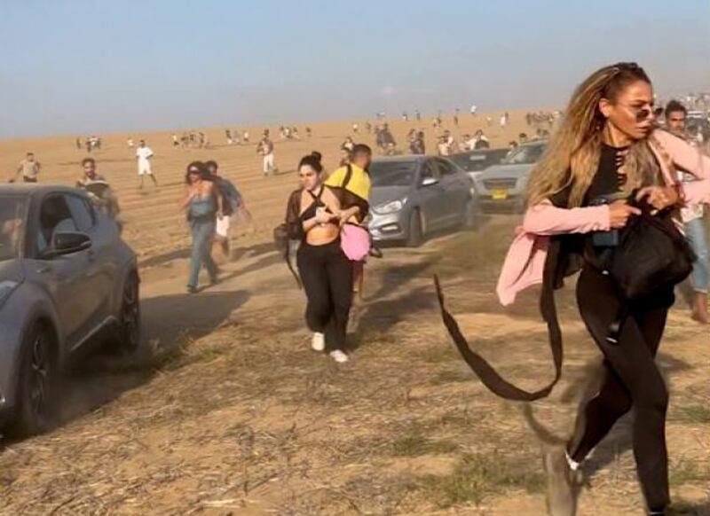Eyewitness footage captures the moment that festival-goers run through a field to escape Hamas gunmen. Supplied