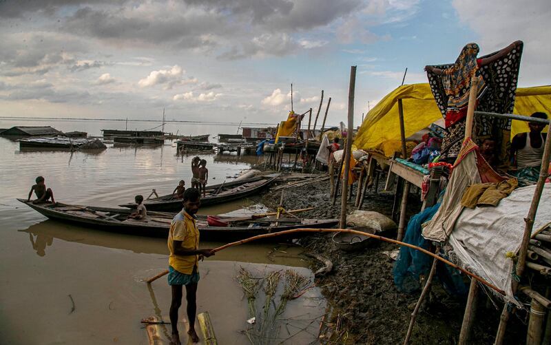 Flood affected people take shelter at temporary structures near their submerged home along the Brahmaputra River in Morigaon district, Assam, India, Thursday, July 16, 2020. Floods and landslides triggered by heavy monsoon rains have killed dozens of people in this northeastern region. (AP Photo/Anupam Nath)