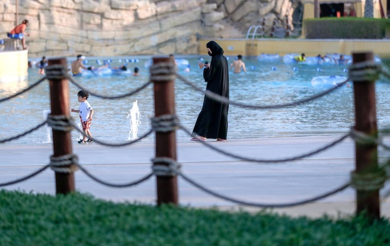 Abu Dhabi, United Arab Emirates, August 4, 2020.   Yas Waterworld Abu Dhabi opens with 30% capacity as Covid-19 restrictions slowly come to an ease.  A mother watches her son at one of the pool areas of the waterpark.
Victor Besa /The National
Section: NA
Reporter: