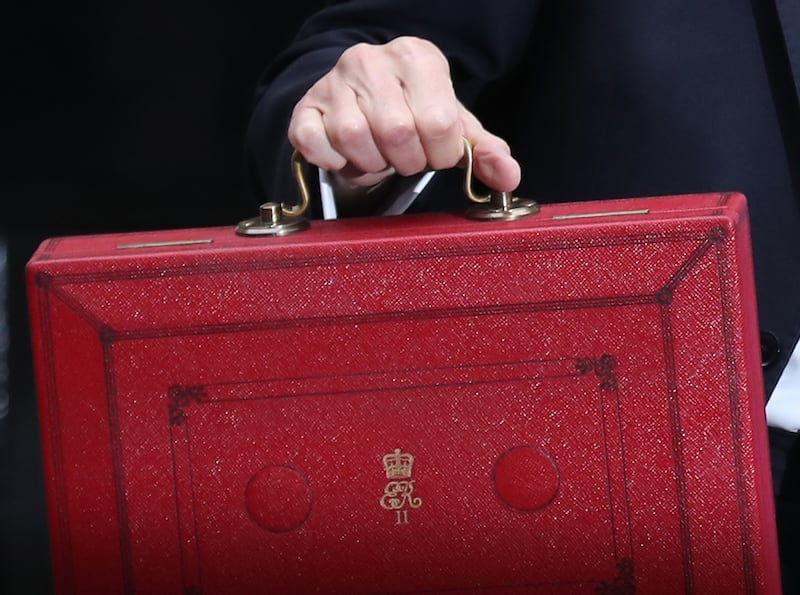 Philip Hammond holds the red case as he departs 11 Downing Street in 2017