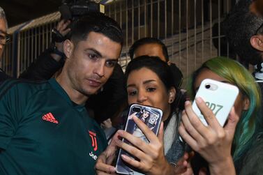 Cristiano Ronaldo of Juventus signing autographs and taking selfies before the training session in Riyadh. Getty