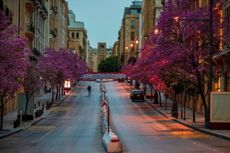 A security man walks along an empty Foch Street before a nighttime curfew imposed by the government to help stem the spread of the coronavirus in Beirut, Lebanon. AP Photo