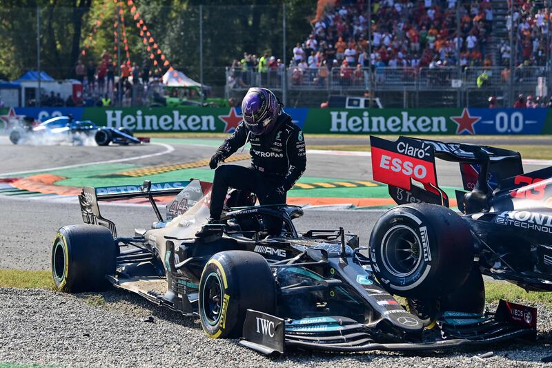 Mercedes' driver Lewis Hamilton gets out of his car following a collision with Red Bull's driver Max Verstappen in Monza. AFP