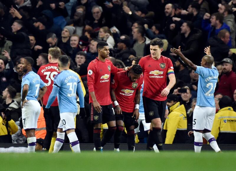 Manchester United's Fred, centre, after items are thrown in his direction. AP