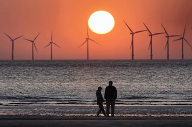 The sun sets behind an offshore wind farm in the Irish Sea. Rishi Sunak's budget will pledge £20m to develop offshore wind demonstration projects to support the government's bid to generate enough electricity from offshore wind to power every home by 2030. Getty Images