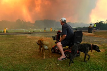 Residents watch as bushfires reach farmland near the town of Nana Glen, about 600km north of Sydney, Australia on November 12, 2019. AFP
