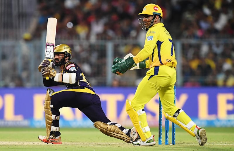 Kolkata Knight Riders captain Dinesh Karthik (L) plays as Chennai Super Kings captain MS Dhoni looks on during the 2018 Indian Premier League (IPL) Twenty20 cricket match between Kolkata Knight Riders and Chennai Super Kings at The Eden Gardens Cricket Stadium in Kolkata on May 3, 2018. / AFP PHOTO / Dibyangshu SARKAR / ----IMAGE RESTRICTED TO EDITORIAL USE - STRICTLY NO COMMERCIAL USE----- / GETTYOUT