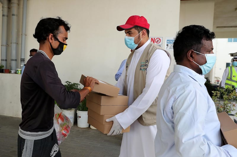 DUBAI, UNITED ARAB EMIRATES , May 01 – 2020 :- Volunteers from Beit Al Khair Society distributing the food packets at one of the labour camp in Al Muhaisnah area in Dubai. This is a part of Mohammed Bin Rashid Al Maktoum 10 Million Meals Global Initiative. Today they are delivering 1000 food packets from Al Nadeg restaurant in Deira Dubai. Total 12000 food packets will be deliver in different labour camps in Dubai. (Pawan Singh / The National) For News/Online/Instagram. Story by Anam