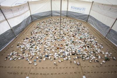 'Another Day Lost', an installation of recycled books and medical boxes housed inside a UNHCR tent, resembles a miniature model of a refugee camp. Courtesy Shubbak